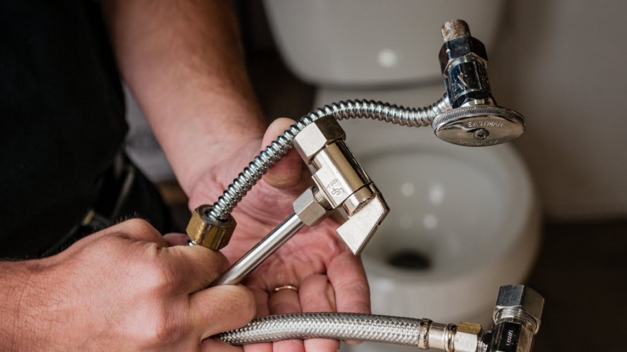 Plumber holding pipes